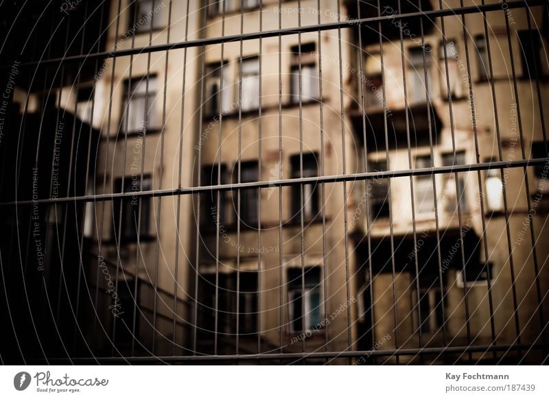 Behind bars Flat (apartment) Redecorate Europe Town Deserted High-rise Building Architecture Facade Balcony Window Fence Old Dirty Dark Brown Safety Protection