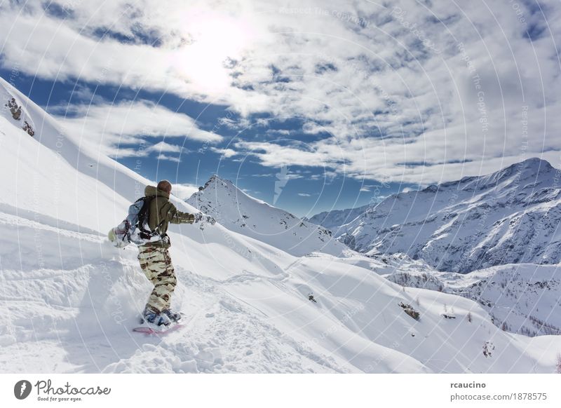 Snowboarder goes downhill over a snowy mountain landscape Vacation & Travel Winter Mountain Sports Skiing Boy (child) Landscape Sky Alps Freeze Speed Clear sky