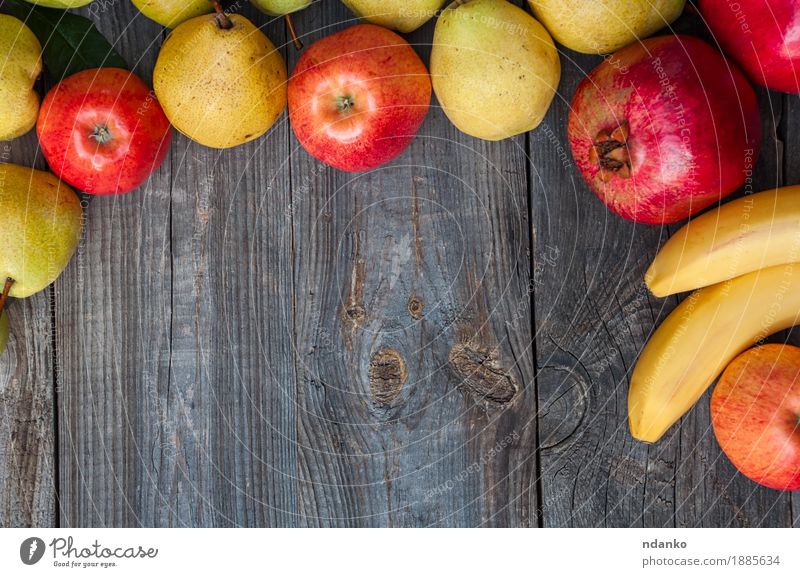 Bananas, pomegranates, apples and pears on a gray wooden surface Food Fruit Apple Nutrition Eating Lunch Vegetarian diet Garden Table Autumn Wood Fresh Natural