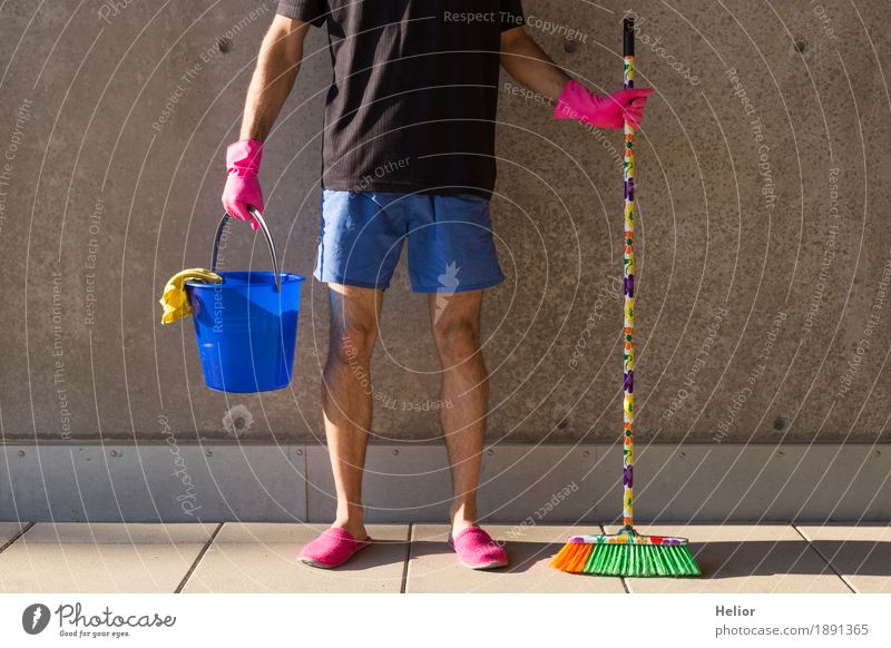 A househusband in pink slippers and cleaning utensils Summer Masculine Man Adults Legs 1 Human being 30 - 45 years Wall (barrier) Wall (building) T-shirt