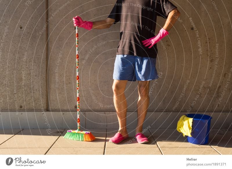 A househusband in pink slippers and cleaning utensils Summer Masculine Man Adults Partner Body 1 Human being 30 - 45 years Wall (barrier) Wall (building)