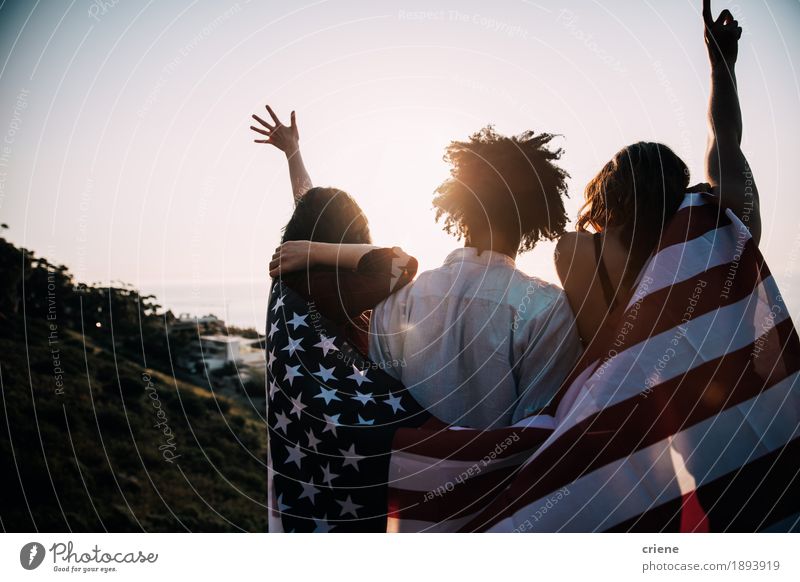 Group of mutli ethnical millennial friends holding USA flag Lifestyle Joy Happy Vacation & Travel Tourism Adventure Freedom Sun Human being Friendship