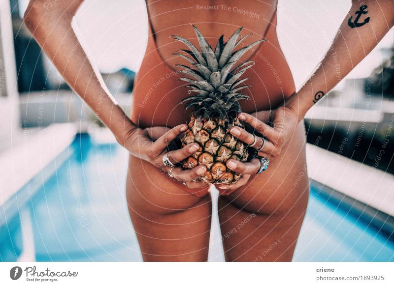 Close-up of women holding pineapple behind her back Fruit Lifestyle Swimming pool Swimming & Bathing Summer Sun Sunbathing Dream house Garden Feminine Woman