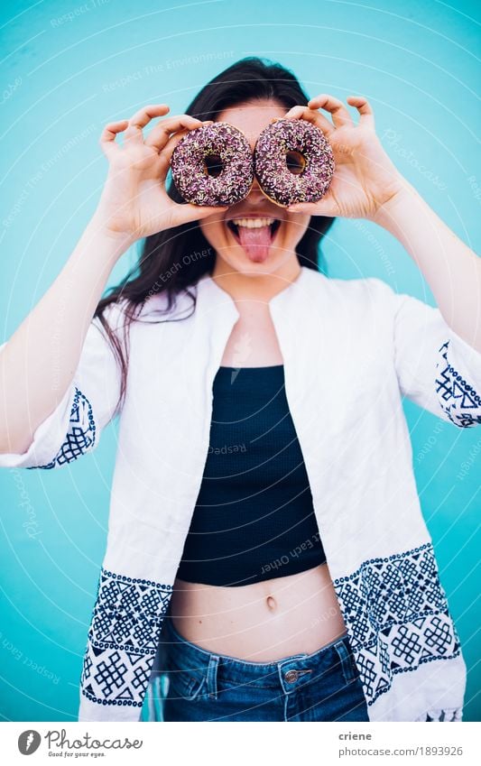 Girl holding chocolate donuts in front of her face Food Cake Dessert Candy Chocolate Eating Fast food Lifestyle Joy Human being Young woman Youth (Young adults)