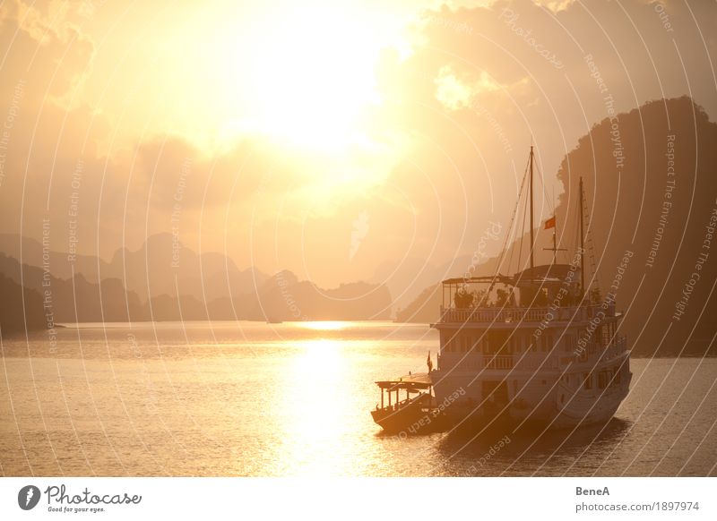 Sunrise behind boat in Ha Long Bay, Vietnam Vacation & Travel Adventure Exotic Nature Halong bay Iceland Sunset World Heritage Site Watercraft Clouds Hill Idyll