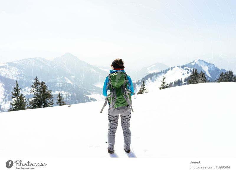 Woman standing in a wintery mountain landscape in the snow at Hochries Relaxation Vacation & Travel Winter Sports Adults Nature Fitness Adventure
