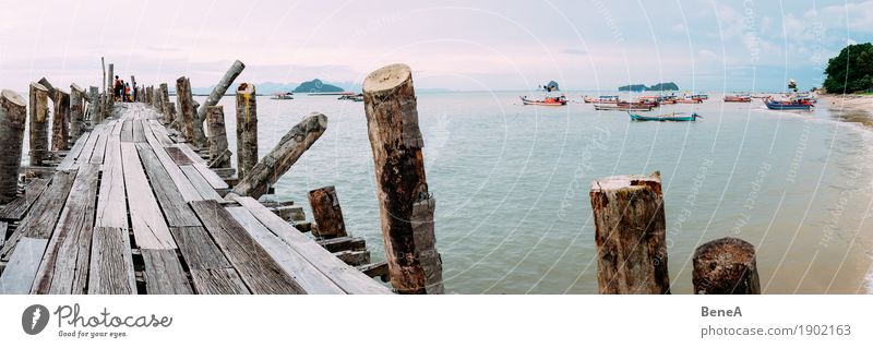 Old wooden jetty and fishing boats in Langkawi Bay, Malaysia Beverage Beach Exotic Nature Vacation & Travel Environment Far-off places Iceland Malaya Jetty
