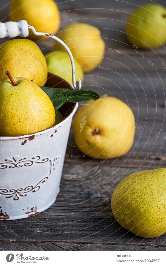 Ripe yellow pears in an iron bucket, gray old wooden surface Fruit Dessert Nutrition Vegetarian diet Diet Crockery Summer Table Nature Autumn Wood Old Fresh