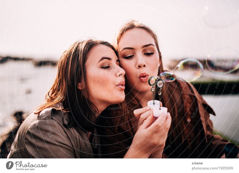 Teenage girls having fun blowing bubbles together Lifestyle Joy Happy Adventure Freedom Feminine Young woman Youth (Young adults) Friendship 2 Human being