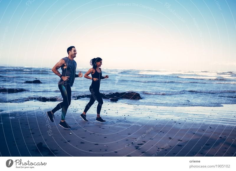 Fit caucasian young adult couple running on beach Lifestyle Joy Body Athletic Leisure and hobbies Summer Beach Ocean Sports Jogging Human being Young woman