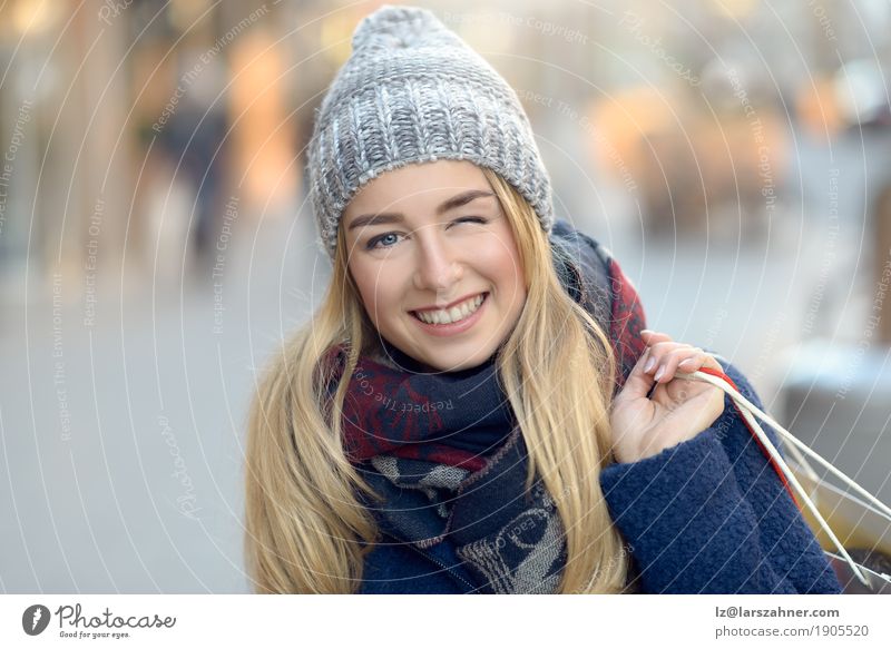 Gorgeous young woman out shopping and blinking Shopping Happy Beautiful Face Winter Woman Adults 1 Human being 18 - 30 years Youth (Young adults) Pedestrian