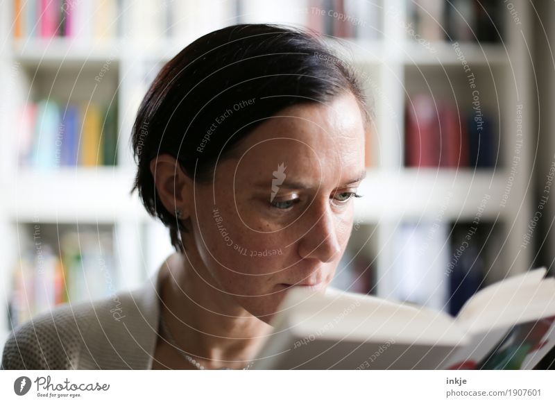 Enjoy time. Lifestyle Leisure and hobbies Reading Bookshelf Woman Adults Face 1 Human being Culture Media Study Interest Colour photo Interior shot Close-up Day