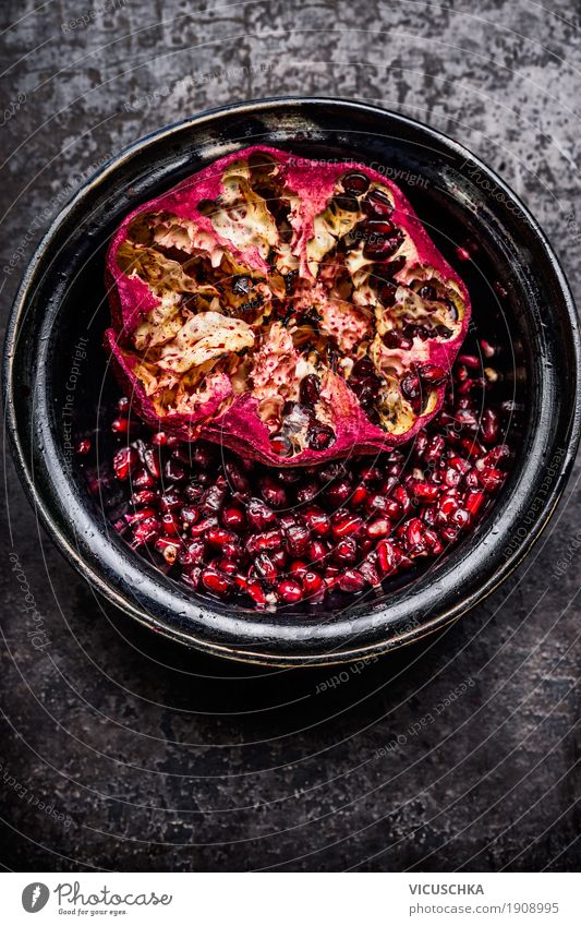 Open pomegranate with seeds in a rustic bowl Food Fruit Nutrition Breakfast Organic produce Vegetarian diet Diet Beverage Bowl Style Design Healthy