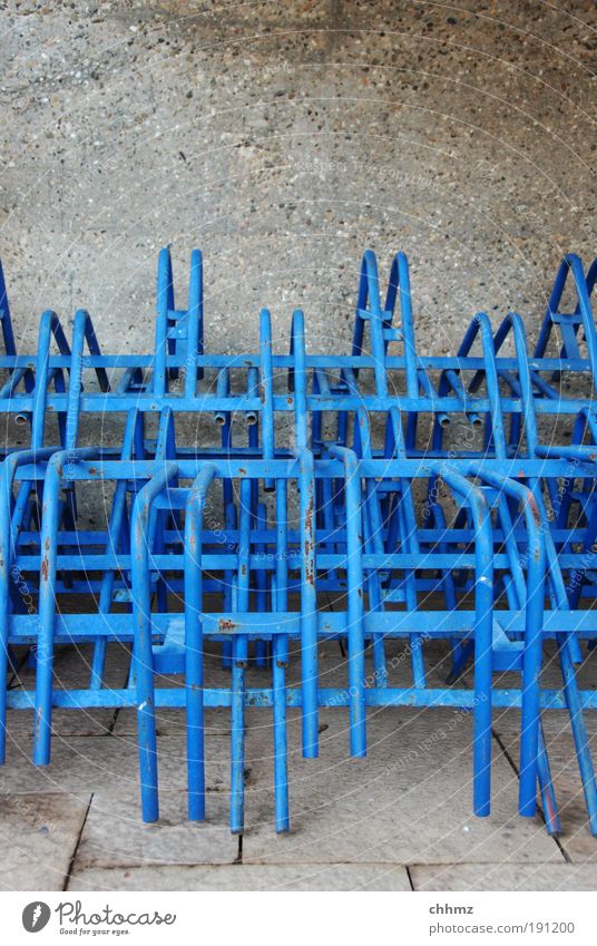 Stacked stands Calm Arrangement Bicycle rack Winter Iron-pipe Blue Pillar Concrete wall Colour photo Exterior shot Close-up Copy Space top Day Long shot
