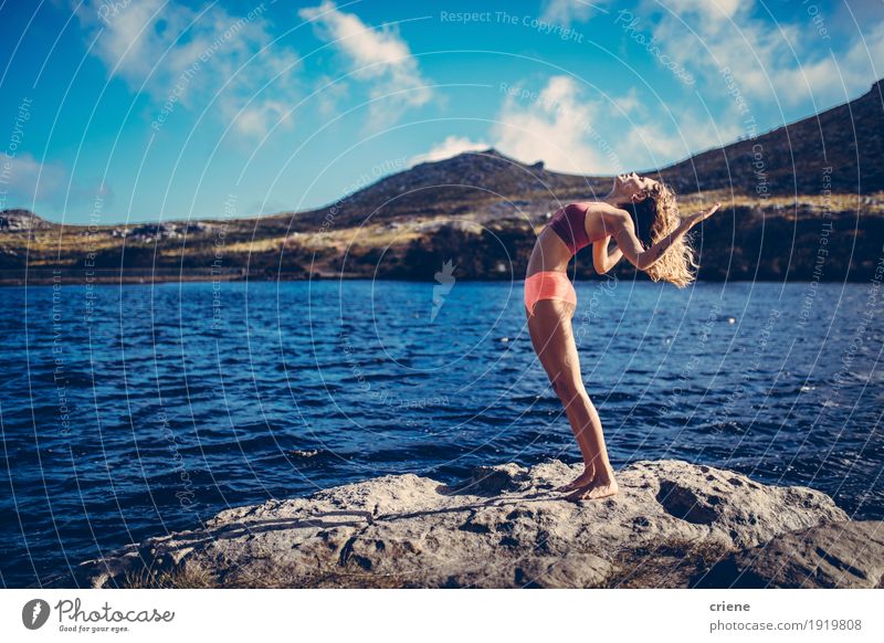 Young beautiful women practising yoga at a lake in nature Lifestyle Joy Meditation Leisure and hobbies Summer Ocean Fitness Sports Training Yoga Human being