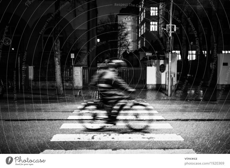night ride Cycling Bicycle Work and employment Office work Human being Town Transport Means of transport Road traffic Street Road sign Zebra crossing Jacket