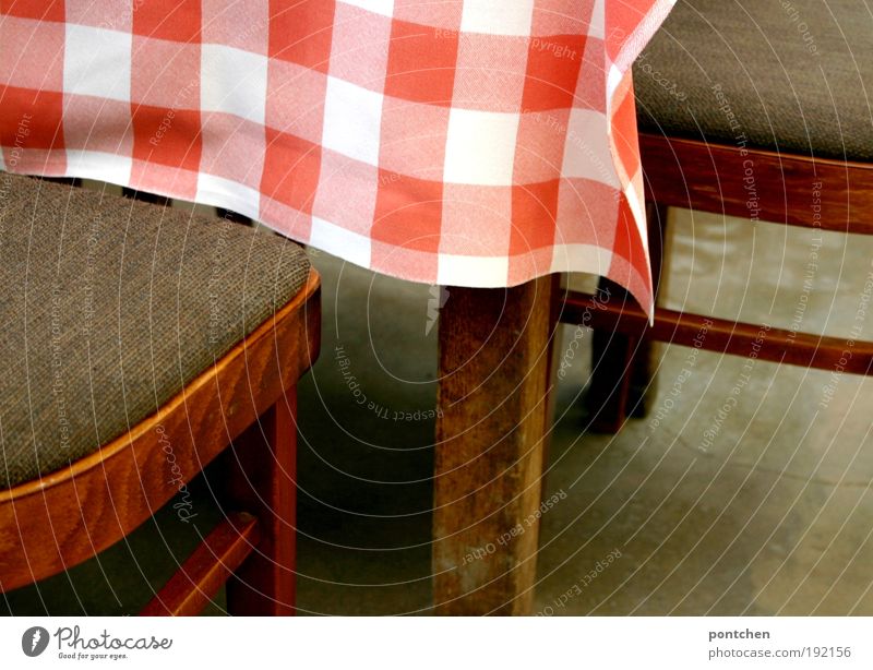 Two chairs stand at a table with red and white tablecloth. Visit to a café or restaurant. Furniture Relaxation Vacation & Travel Tourism Trip Living or residing