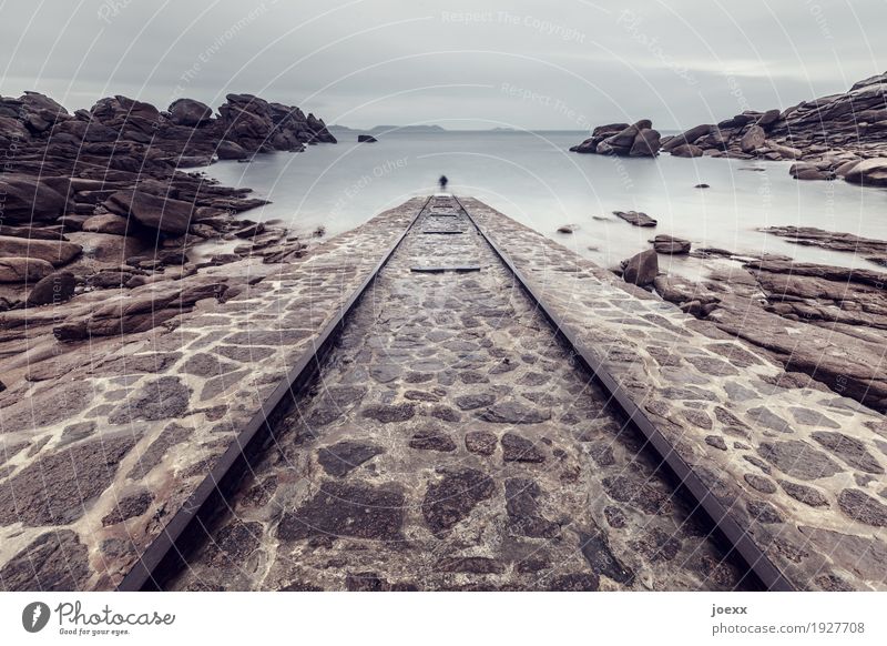 Rails on a ramp lead directly into the sea, long time exposure Landscape Sky coast Maritime Clouds Horizon Weather Bad weather Rock France Wall (barrier)