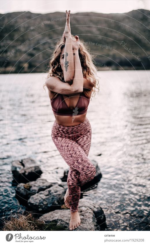 Young female adult doing yoga pose outdoors at a lake Lifestyle Meditation Leisure and hobbies Sports Fitness Sports Training Yoga Human being Feminine
