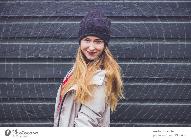 Young woman at a wooden fence Feminine Youth (Young adults) Life 1 Human being 18 - 30 years Adults Sweater Jacket Coat Cap Blonde Long-haired Movement Rotate
