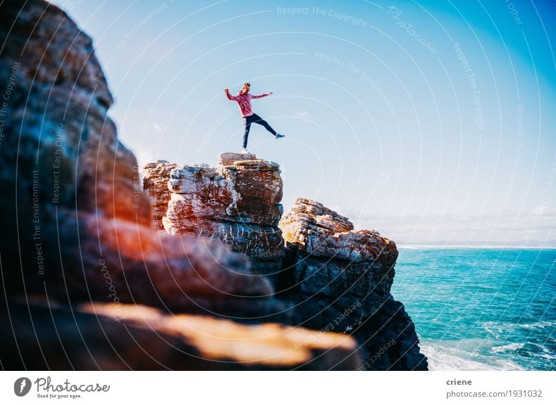 Young happy man balancing on cliff at the ocean Lifestyle Joy Happy Vacation & Travel Trip Adventure Freedom Ocean Waves Hiking Human being Masculine Young man