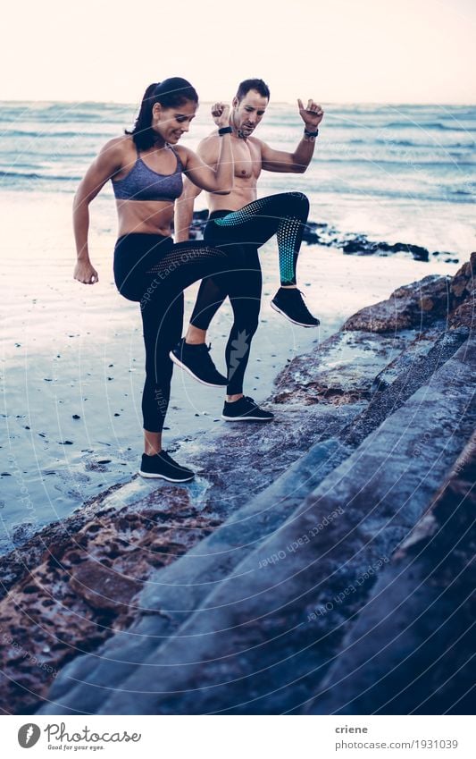 Sporty couple training together on the beach Lifestyle Joy Body Beach Ocean Waves Sports Fitness Sports Training Woman Adults Man Couple Youth (Young adults)