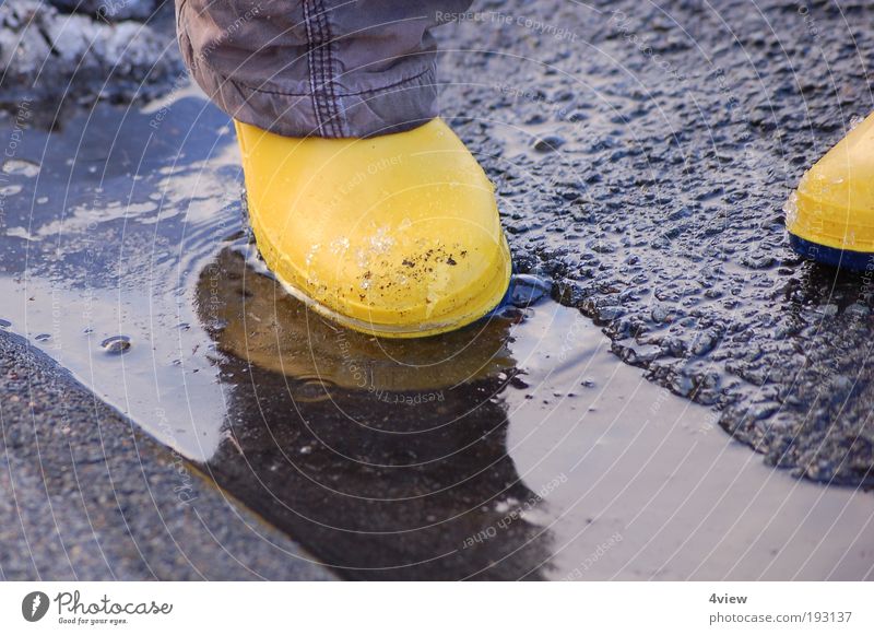 watertight Rubber boots Stone Water Movement Cleaning Jump Fresh Wet Under Yellow Joy Serene Colour photo Exterior shot Copy Space bottom Twilight