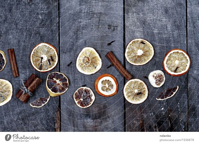 Slices of orange and lemon on a gray wooden surface Fruit Dessert Herbs and spices Table Christmas & Advent Tree Wood Old Fresh Delicious Natural Above Retro