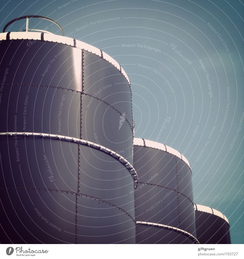 by the ton Industrial plant Factory Large Round Keg Containers and vessels Industry Tank Cylinder Geometry Sky Worm's-eye view Gas tank Energy industry Tower