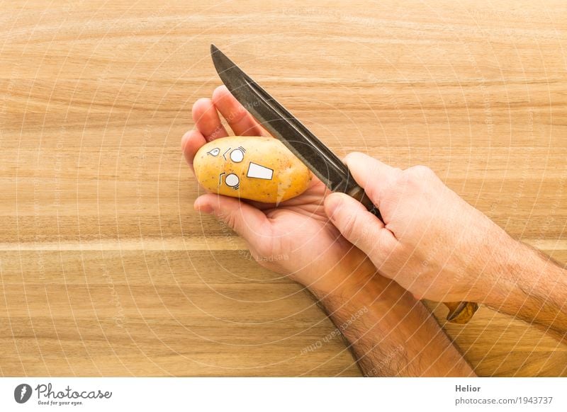 Potato in panic fear of a sharp armor knife - a Royalty Free Stock Photo  from Photocase