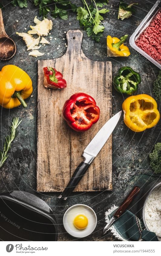 Paprika on cutting board with kitchen knife and ingredients Food Meat Vegetable Herbs and spices Nutrition Lunch Dinner Organic produce Crockery Bowl Pot Knives
