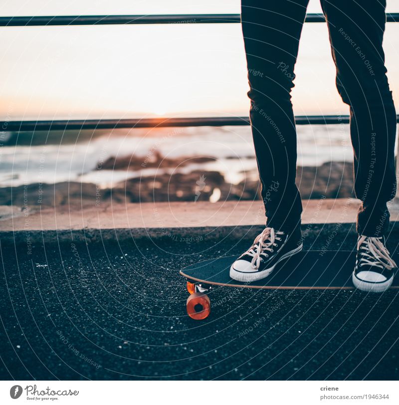 Close-up of man standing on longboard on promenade Lifestyle Style Joy Leisure and hobbies Beach Ocean Sports Human being Masculine Young man