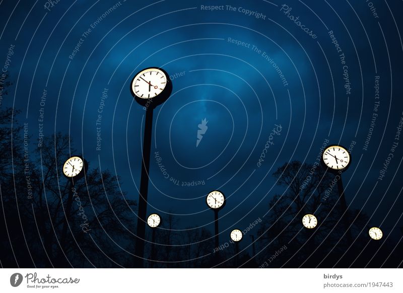 Many luminous watches in the Uhrenpark Düsseldorf at night Clock face time change Clouds Night sky Park Illuminate Exceptional Tall Blue Black White