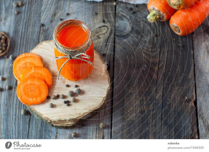 Fresh carrot juice in a glass jar on a wooden surface Vegetable Herbs and spices Nutrition Vegetarian diet Diet Beverage Juice Bottle Healthy Eating Table