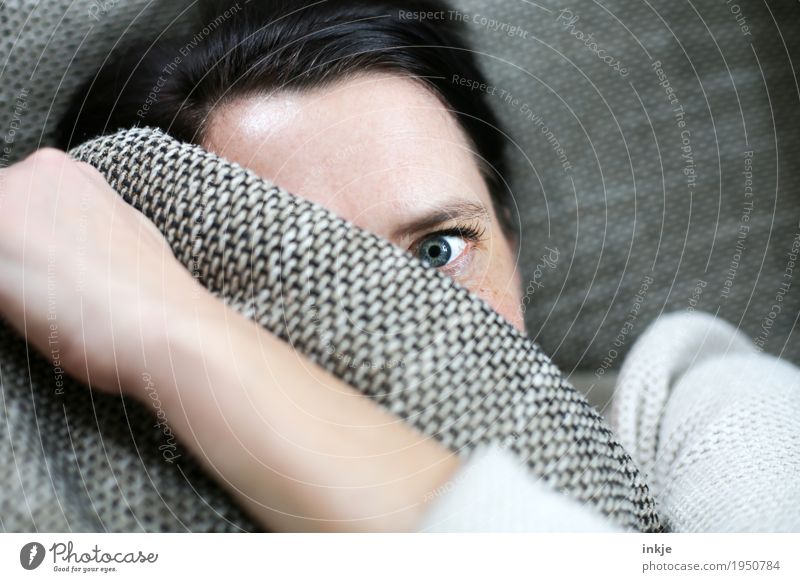 Woman hiding behind pillow Lifestyle Living or residing Sofa Adults Face Eyes 1 Human being 30 - 45 years 45 - 60 years Cushion Observe Looking Emotions Moody