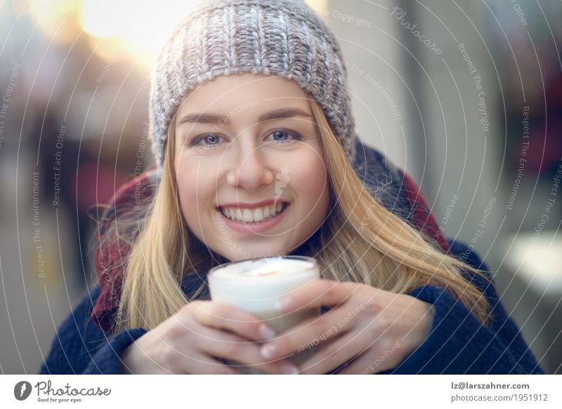 Young adult white woman with big cup of latte - a Royalty Free Stock Photo  from Photocase