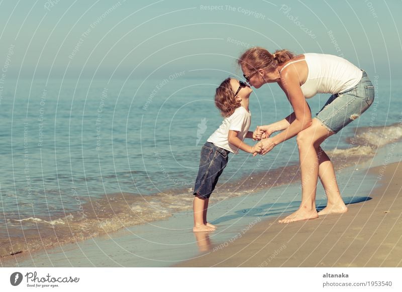 Mother and son playing on the beach at the day time. Lifestyle Joy Relaxation Leisure and hobbies Playing Vacation & Travel Trip Freedom Summer Sun Beach Ocean