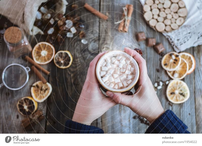 Women's hands are holding a cup of hot drink Fruit Dessert Candy Breakfast To have a coffee Beverage Hot Chocolate Coffee Cup Mug Decoration Table Woman Adults