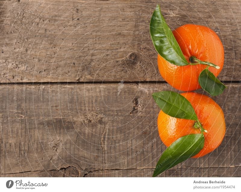 Two oranges Food Fruit Healthy Delicious Sweet Yellow Orange wood leaf Background picture fresh freshness diet agriculture ingredient Vitamin juicy brown wooden