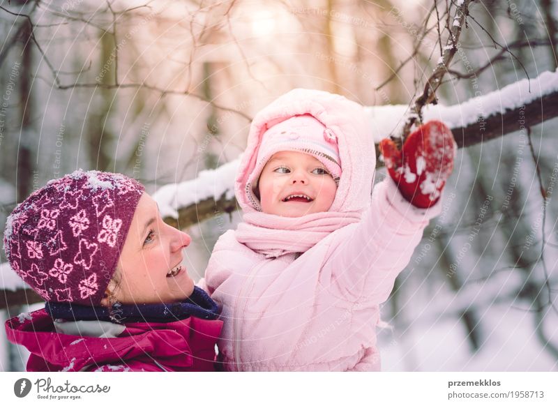 Mother spending time with her little daughter outdoors Lifestyle Joy Happy Leisure and hobbies Winter Snow Child Human being Baby Girl Woman Adults Parents