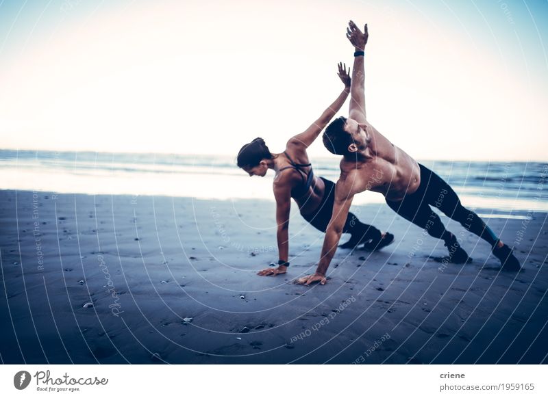 Young adult couple doing fitness exercises on beach Lifestyle Body Athletic Fitness Well-being Leisure and hobbies Beach Ocean Sports Sports Training