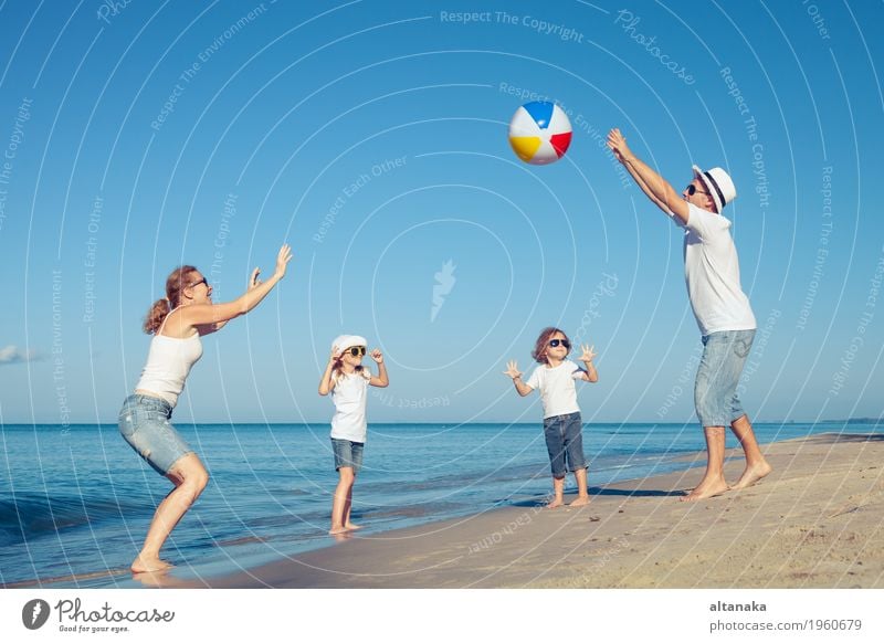 Happy family playing on the beach at the day time. Lifestyle Joy Relaxation Leisure and hobbies Playing Vacation & Travel Trip Freedom Summer Sun Beach Ocean