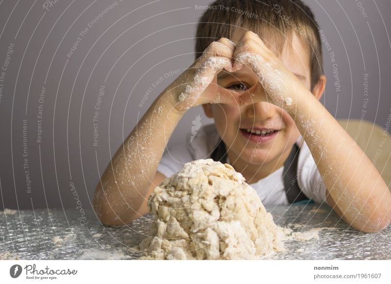 Boy is kneading raw dough looking through heart shape hands Dough Baked goods Bread Joy Playing Kitchen Child Boy (child) Infancy Hand Heart Smiling Make