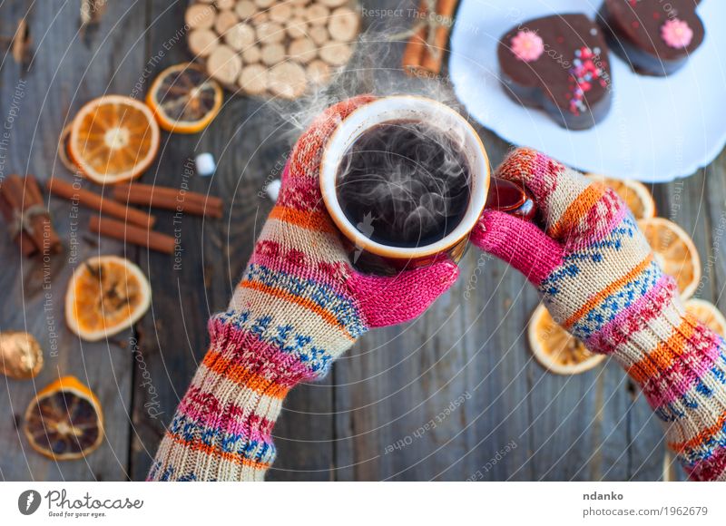 cup of black coffee in his hands over the table Fruit Dessert Candy Herbs and spices Breakfast To have a coffee Beverage Hot drink Coffee Espresso Plate Cup