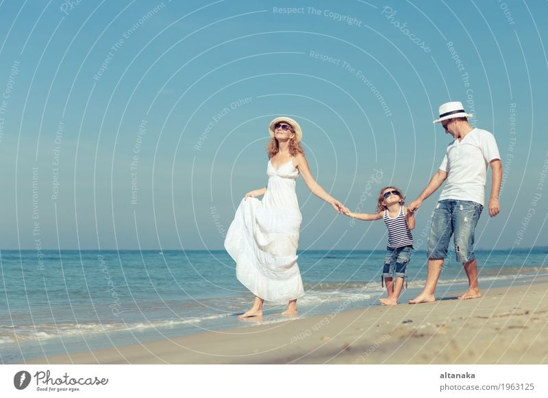 Happy family walking on the beach at the day time. Lifestyle Joy Relaxation Leisure and hobbies Playing Vacation & Travel Trip Freedom Summer Sun Beach Ocean