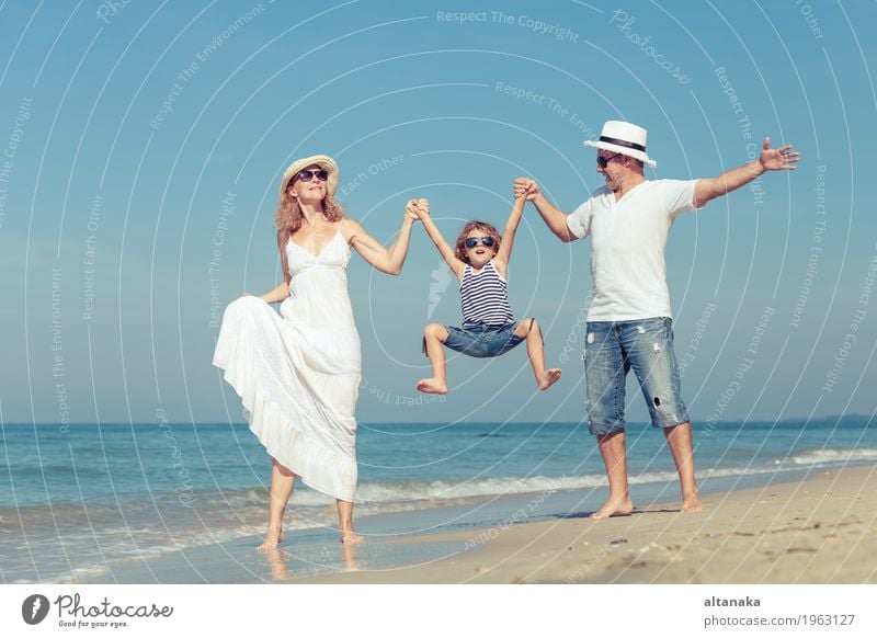 Happy family walking on the beach at the day time. Lifestyle Joy Relaxation Leisure and hobbies Playing Vacation & Travel Trip Freedom Summer Sun Beach Ocean