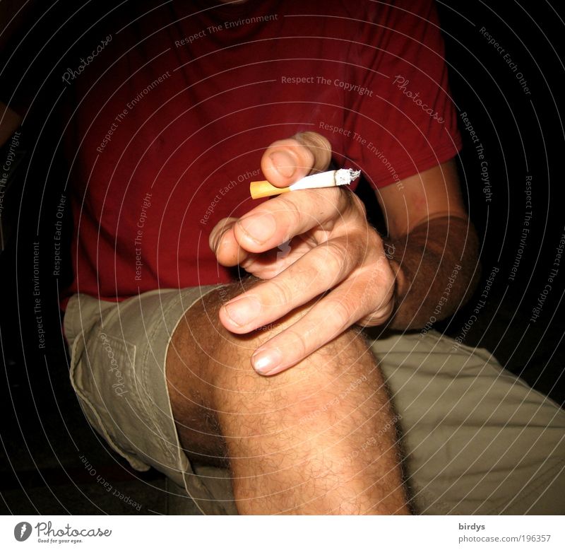 sitting man with short pants and burning cigarette in his hand Masculine Man Adults by hand Fingers Legs 1 Human being T-shirt Smoking Red Vice nervousness