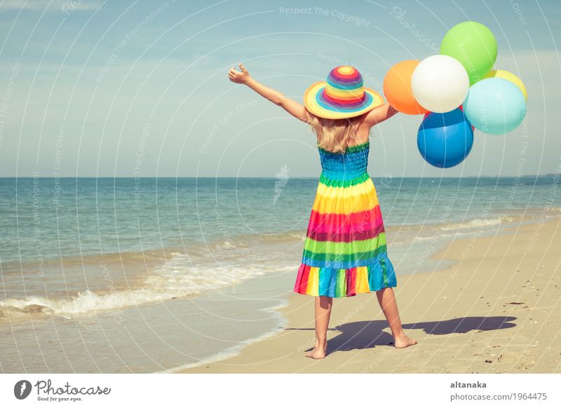 Little girl with balloons standing on the beach Lifestyle Joy Happy Relaxation Leisure and hobbies Playing Vacation & Travel Trip Adventure Freedom Summer Sun