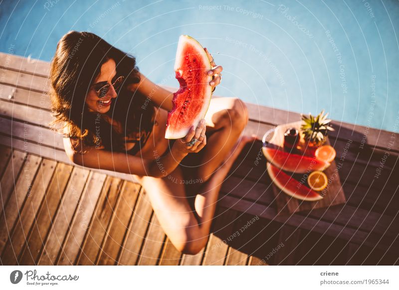 Young beautiful women in bikini sitting at swimming pool Fruit Orange Eating Lifestyle Joy Swimming pool Swimming & Bathing Summer Summer vacation Sunbathing