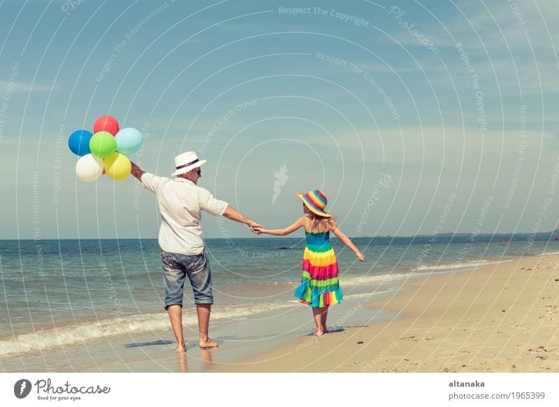 Father and daughter with balloons playing on the beach Lifestyle Joy Relaxation Leisure and hobbies Playing Vacation & Travel Trip Freedom Summer Sun Beach